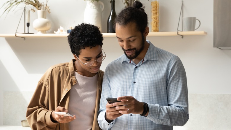 two people looking at phones