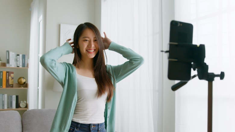 A woman creating a TikTok