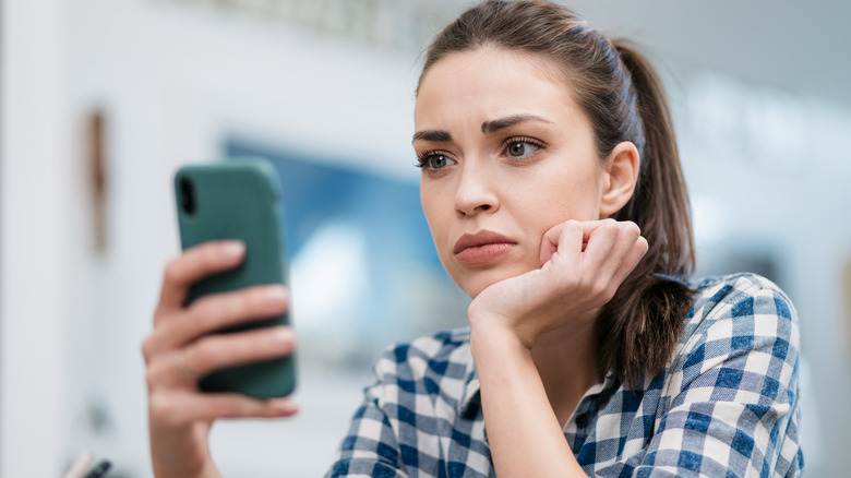 woman looking at phone