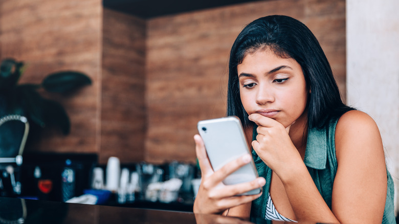 concerned lady looking at phone