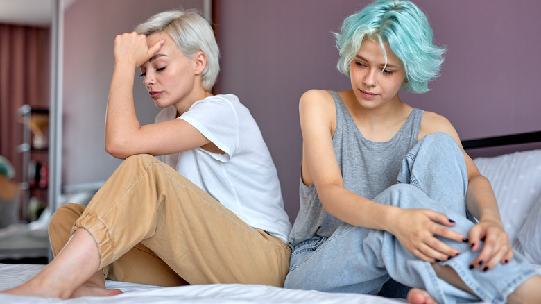 Two women sitting sad