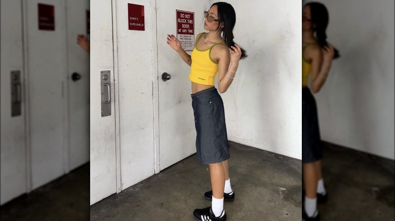 Girl yellow tank grey skirt