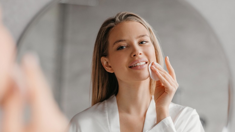 woman applying skincare product
