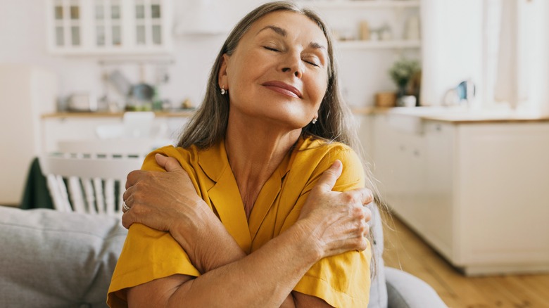 Woman hugs herself