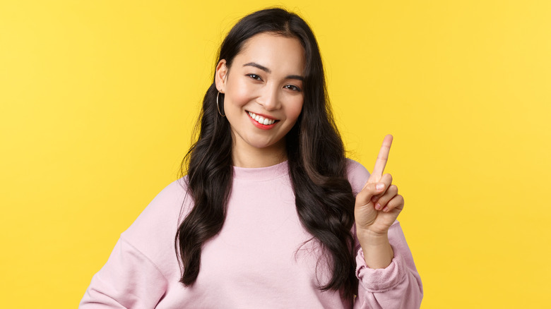 Woman holding up one finger