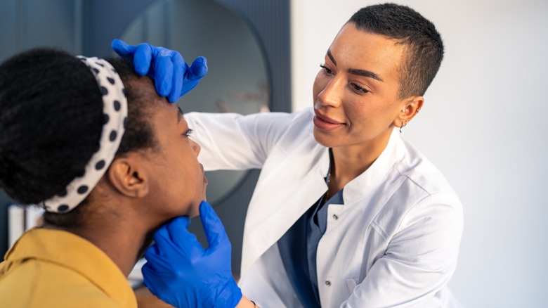 Dermatologist examining patient lips