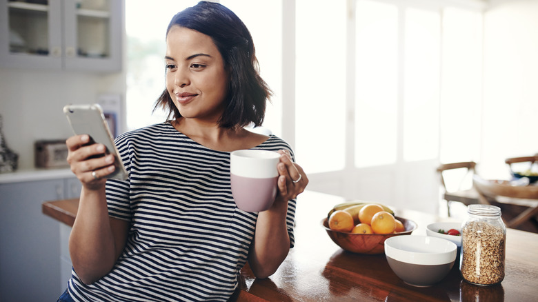 Woman smirks at phone
