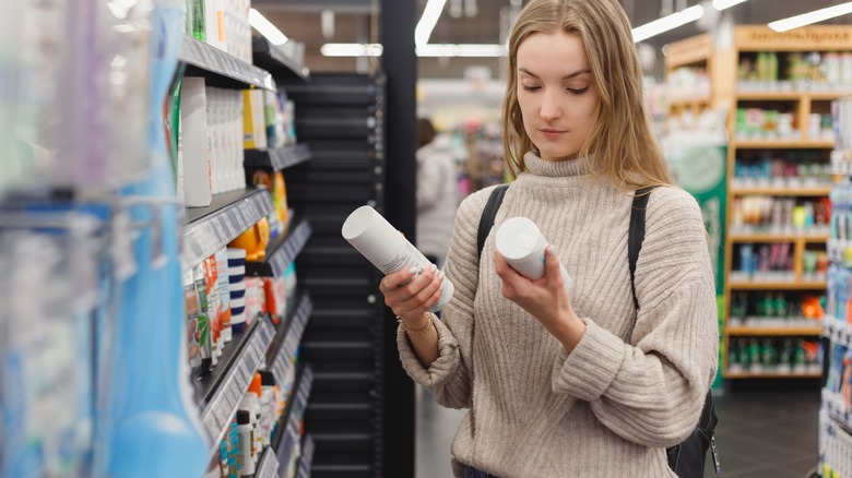 woman shopping for shampoo