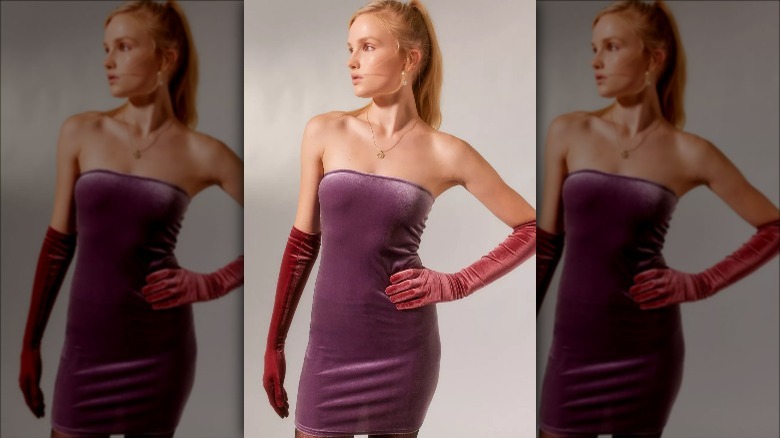 UO model wears velvet dress and matching gloves