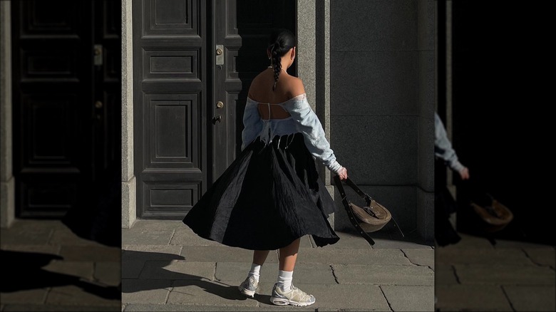 Woman wearing sweater over skirt