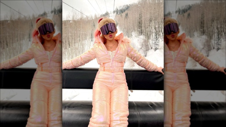 Individual in iridescent pink snowsuit