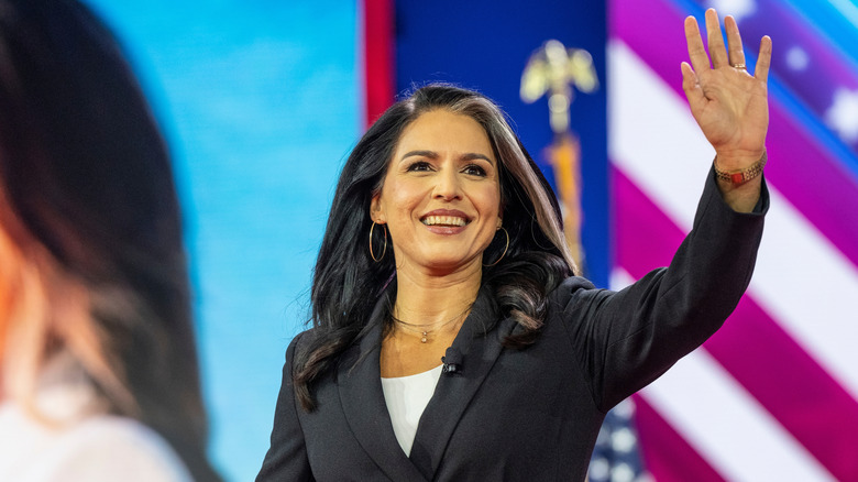 Tulsi Gabbard waves at a political rally