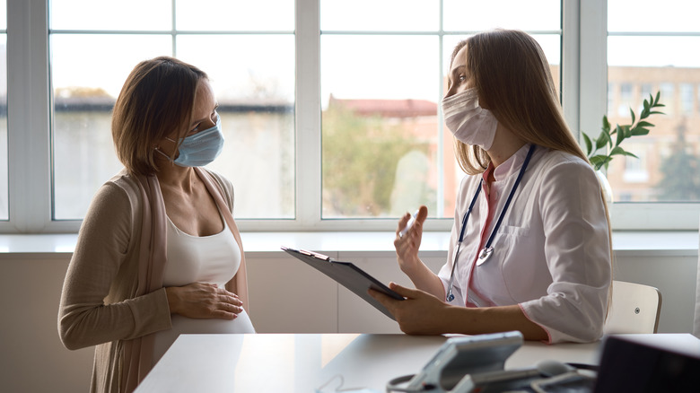 Pregnant woman with doctor