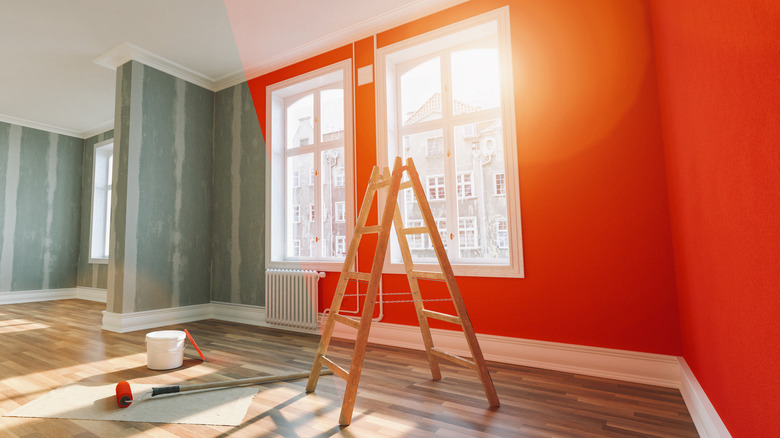 A drab room half painted orange