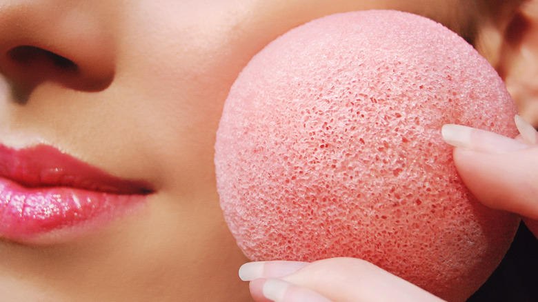 woman with pink konjac sponge