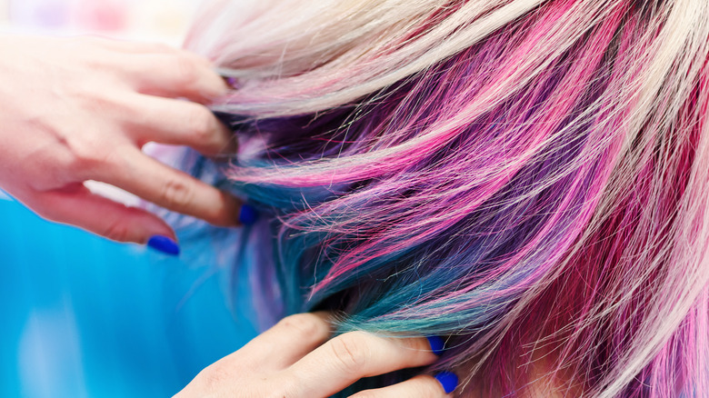 Stylist's hands separating client's hair