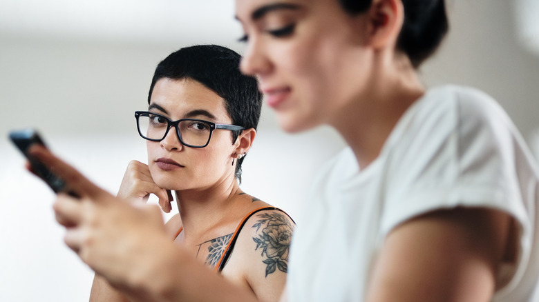 Person on phone ignoring their partner