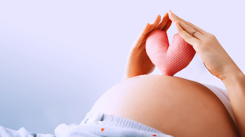 Pregnant woman with heart symbol