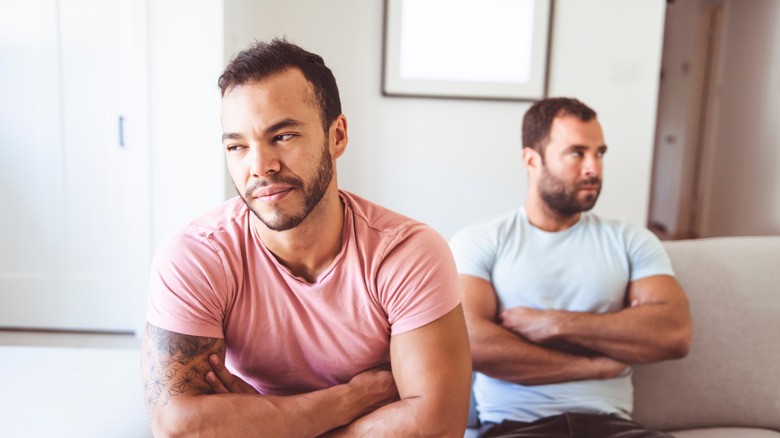 two men with arms crossed 