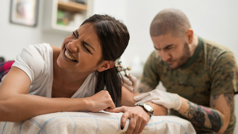 person getting a painful tattoo