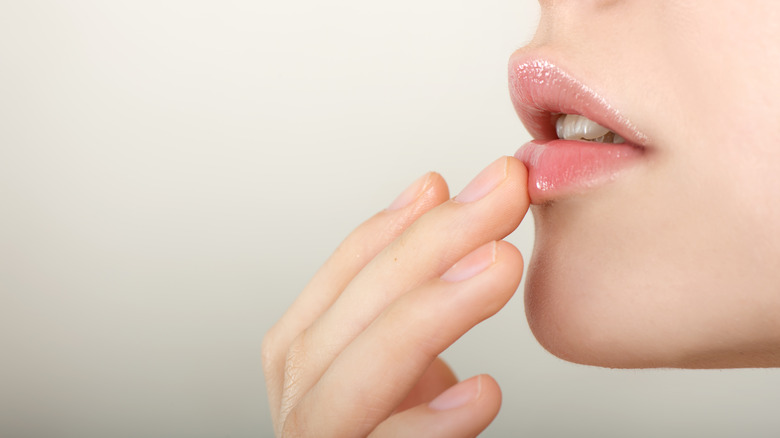 woman touching her lips