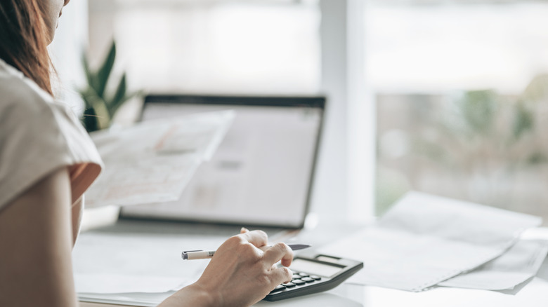 woman using calculator