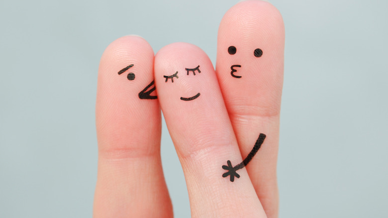 Three fingers with faces drawn