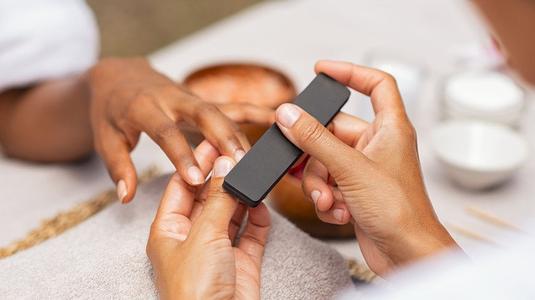 Woman getting manicure