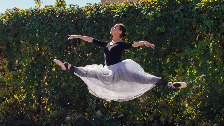 Ballerina dancing outdoors.
