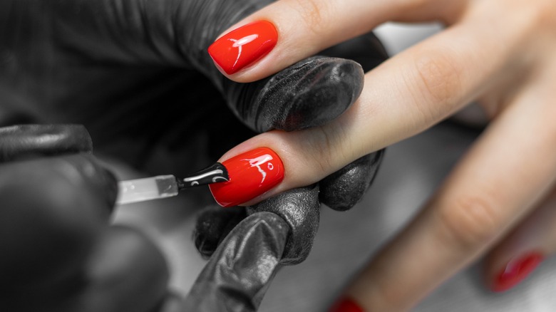 Nail artist painting red nails