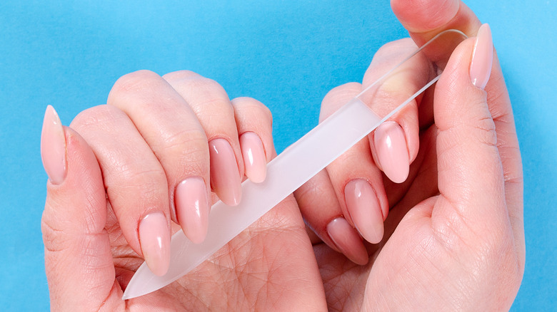Hands holding a crystal nail file