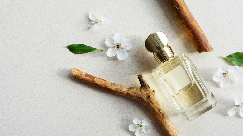 perfume laying with flowers