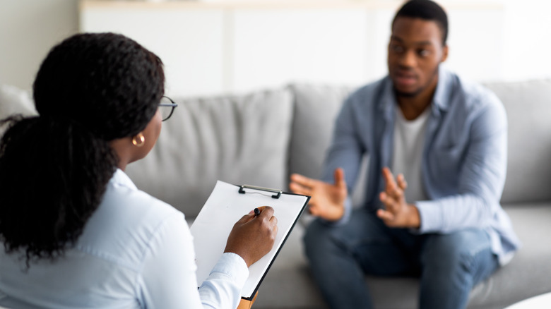 Man speaking to female therapist