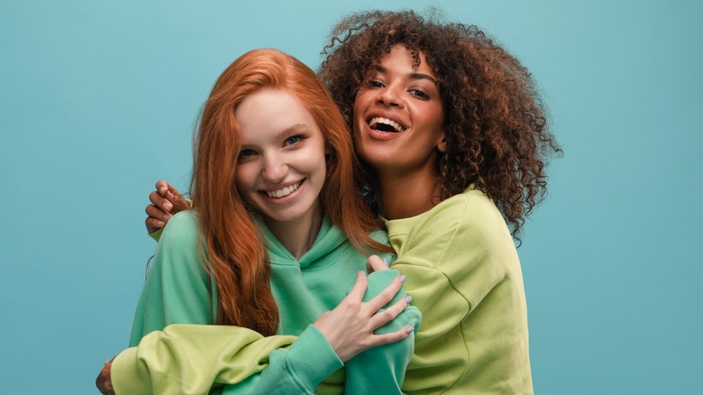 two smiling women hugging