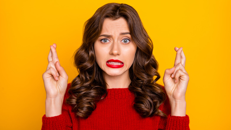 Woman crossing fingers for luck