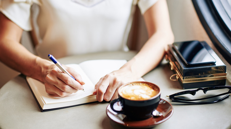 Person writing in their journal
