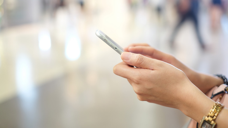 Woman uses iPhone in public
