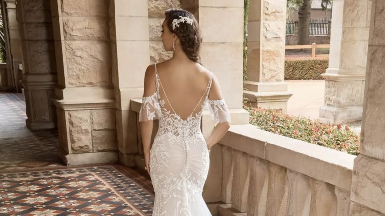 Bride showing vintage dress back