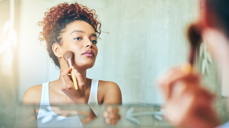 Woman applying bronzer