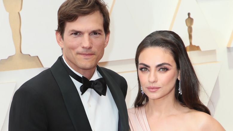Ashton Kutcher and Mila Kunis posing