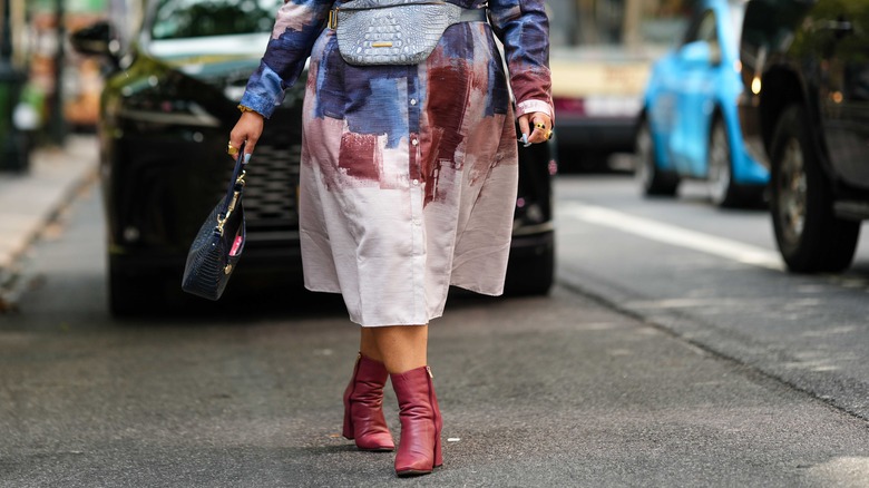 woman wearing red ankle boots