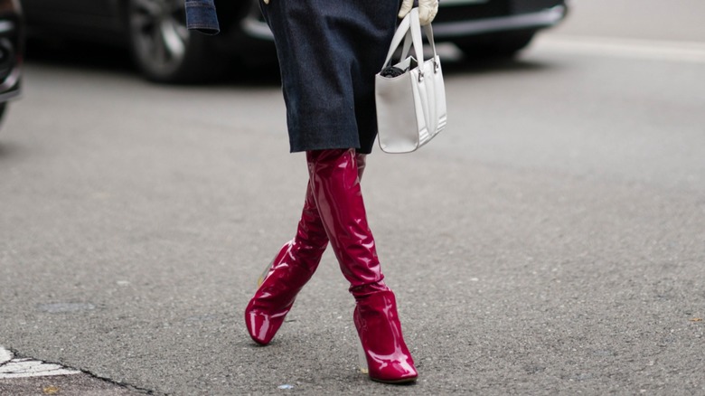 woman wearing red knee-high boots