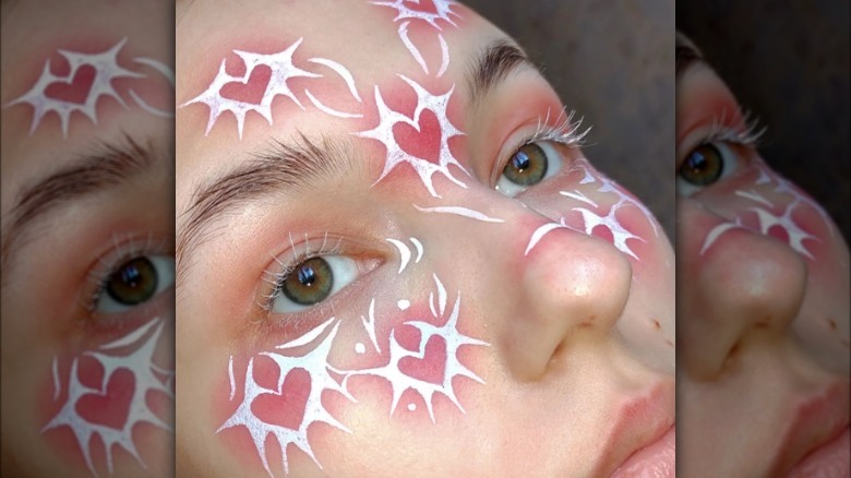 woman models white face paint 