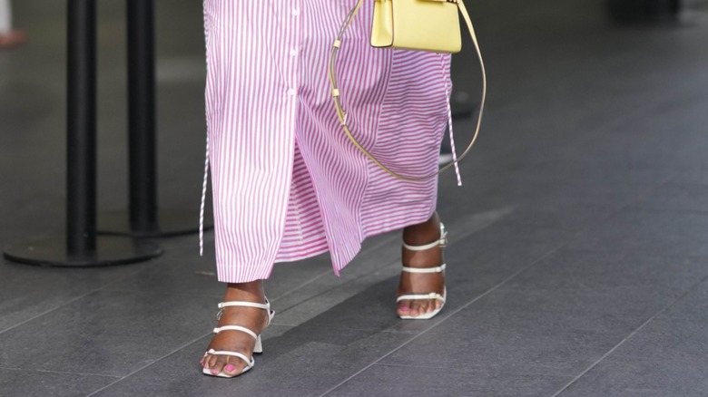 woman wearing white strappy sandals