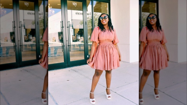 Woman wearing pink dress and white shoes