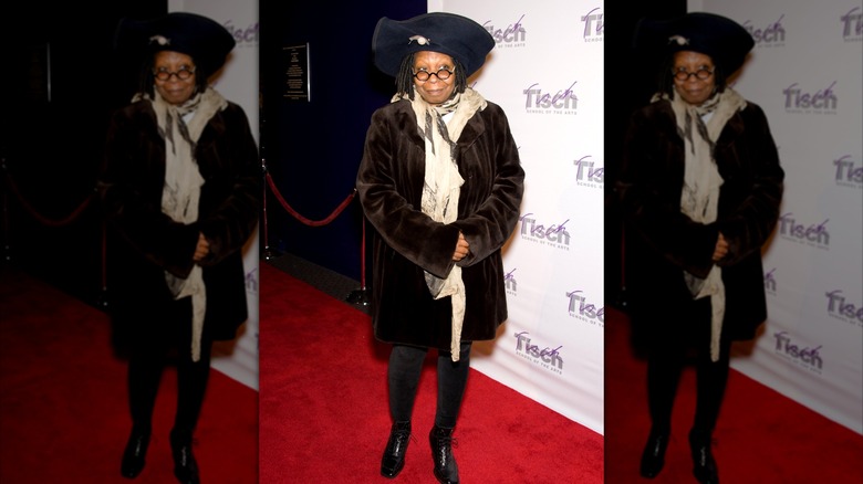 Whoopi Goldberg wearing a coat, scarf, and huge beret at a 2010 gala.