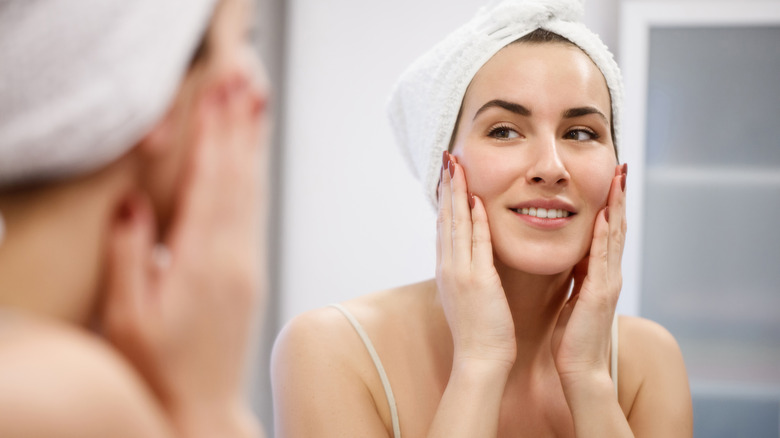 Woman looking in spa mirror