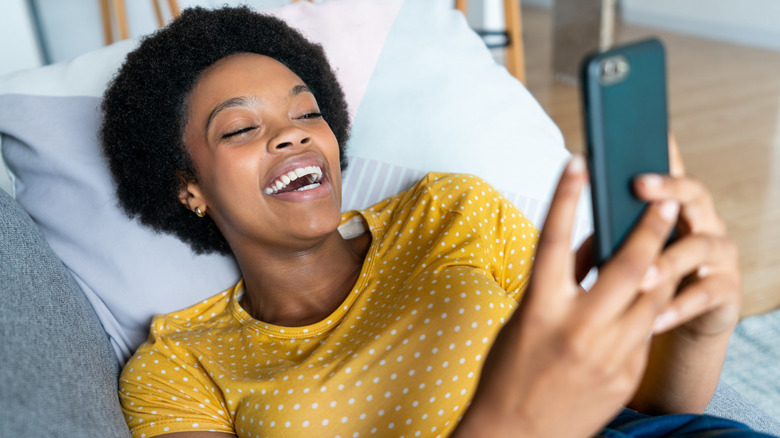 woman laughing at phone