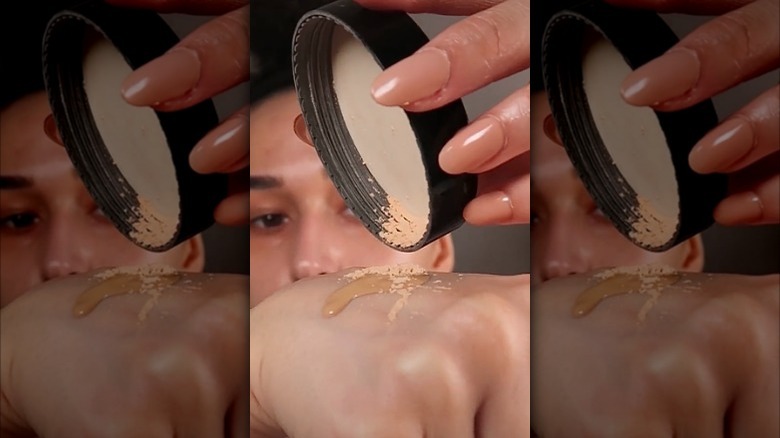 TikTok creator mixing foundation and powder 