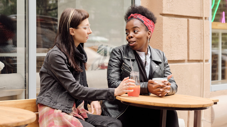 women talking at outdoor cafe